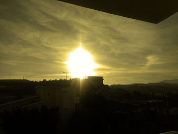 Buildings against sky at sunset