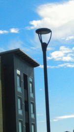 Low angle view of street light against blue sky