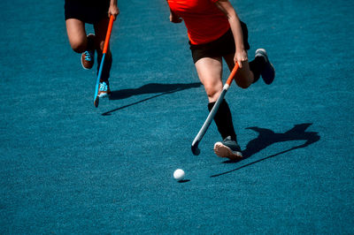 Low section of men playing with ball