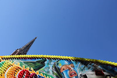 Low angle view of multi colored against clear blue sky