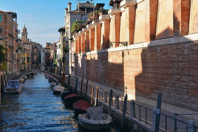 View of canal amidst buildings in city