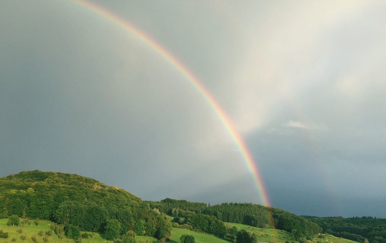 rainbow, double rainbow, beauty in nature, scenics, nature, idyllic, multi colored, weather, tranquility, no people, tranquil scene, outdoors, day, sky, mountain, green color, tree, spectrum