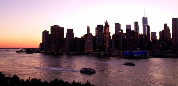 City at waterfront during sunset