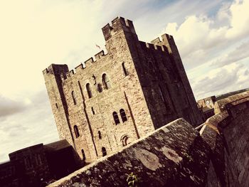 Low angle view of castle against cloudy sky