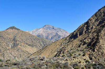 Scenic view of mountains against clear blue sky