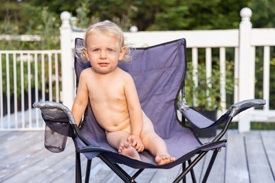 Portrait of young woman sitting on chair