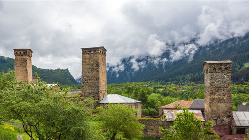 Old ruins by building against sky