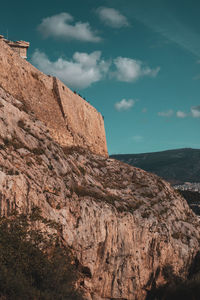 Low angle view of rock formation against sky