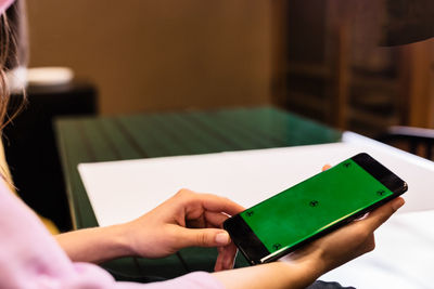 Midsection of woman using mobile phone