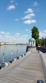 Pier over river against blue sky