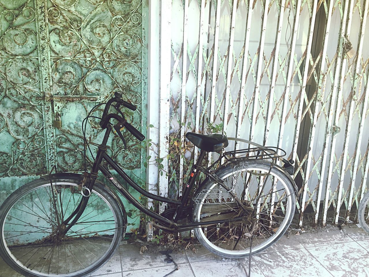 BICYCLE PARKED BY RAILING