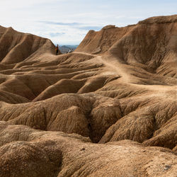 Scenic view of arid landscape against sky