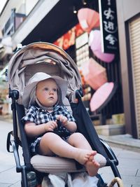 Portrait of baby sitting in stroller 