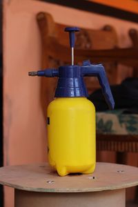 Close-up of yellow bottles on table