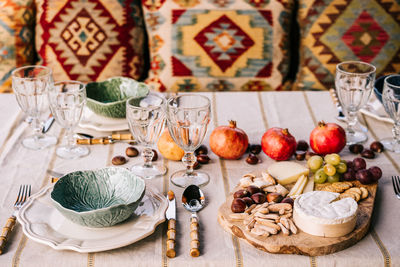 Table served with tableware and assorted ripe fruits and delicious appetizers on terrace