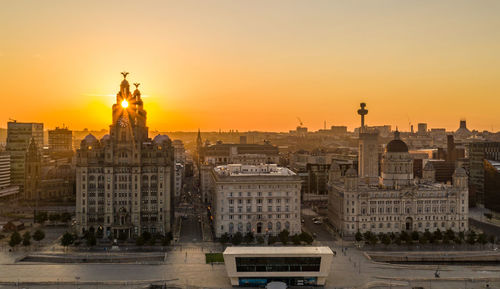 Buildings in city during sunset