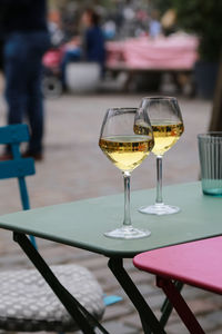 Close-up of wine glasses on table at cafe