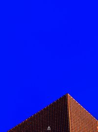 Low angle view of building against clear blue sky