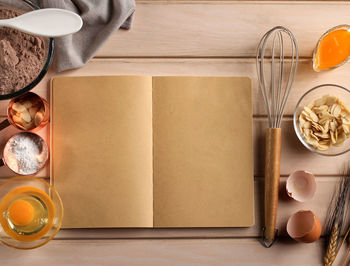 Empty open book with baking ingredients, top view. concept book recipe for advertisement