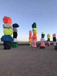 Multi colored umbrellas on beach against clear sky