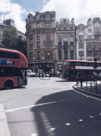 Vehicles on road against buildings in city