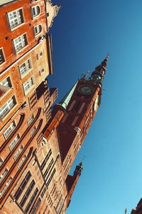 Low angle view of built structure against clear blue sky