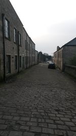 Empty footpath leading towards building