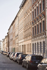 Cars on road against buildings in city