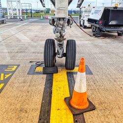 Close-up of airplane on runway at airport