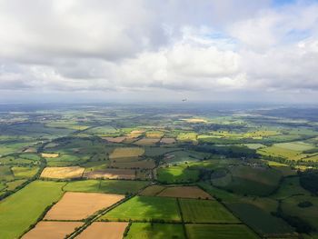 Aerial view of agricultural landscape against sky