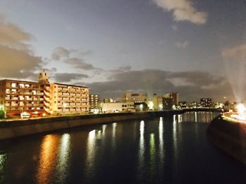 Illuminated cityscape against sky