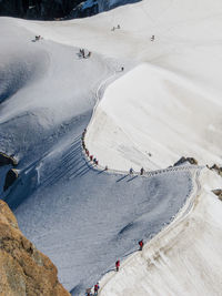 High angle view of people on snow covered landscape