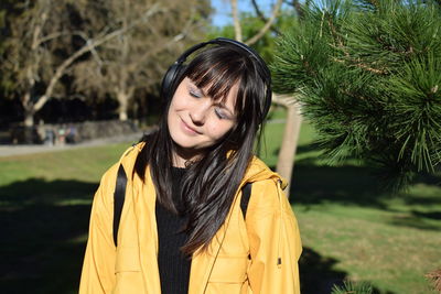 Portrait of a beautiful young woman standing outdoors