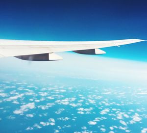 Airplane wing against blue sky