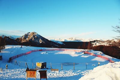 Scenic view of snowcapped mountains against clear blue sky