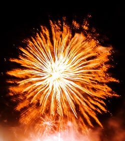 Low angle view of firework display at night