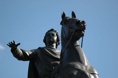 Low angle view of statue against clear blue sky