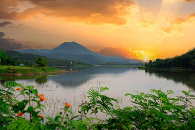 Scenic view of lake against orange sky