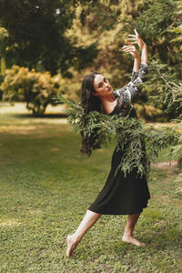 Full length of woman with arms raised on land