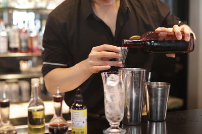 Midsection of man preparing food in kitchen