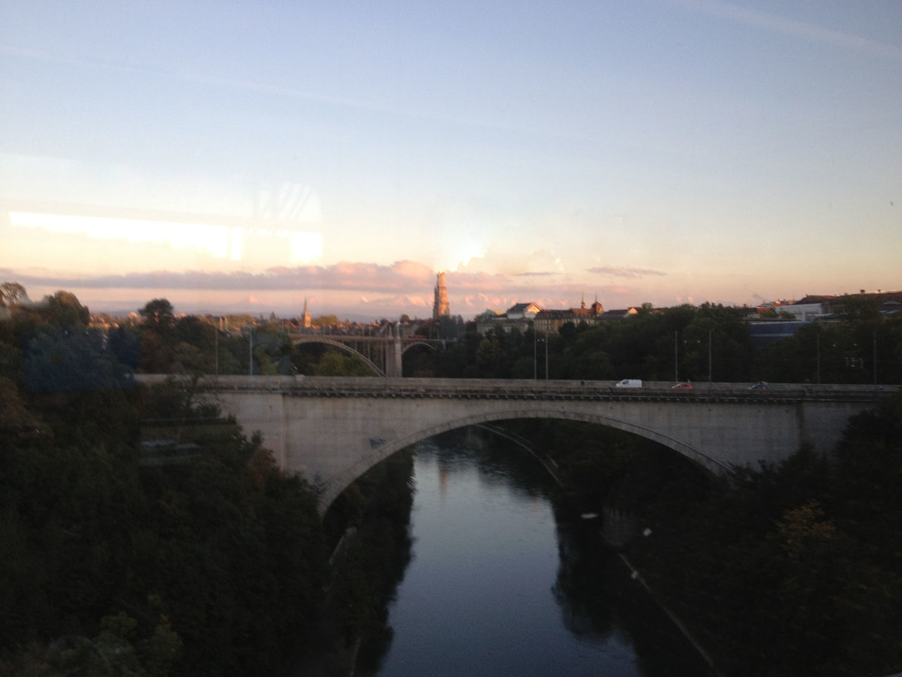 BRIDGE OVER RIVER IN CITY AGAINST SKY