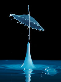 Close-up of splashing water over black background