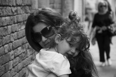 Portrait of mother and daughter outdoors