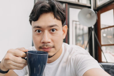Portrait of man drinking coffee