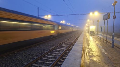 A passenger train entering the station in the fog. night train passing the station. the concept of