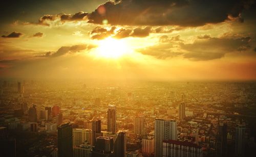 Aerial view of city against sky during sunset