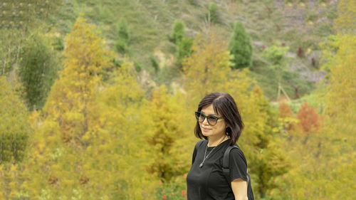 Portrait of young woman in sunglasses during autumn