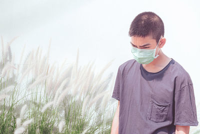 Protection against contagious disease, coronavirus. asian young boy wearing hygienic mask, covid-19