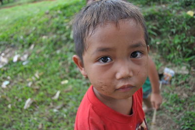 Portrait of cute boy on field