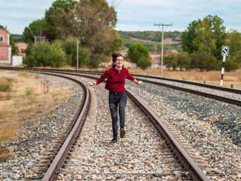 Full length of man standing on railroad track